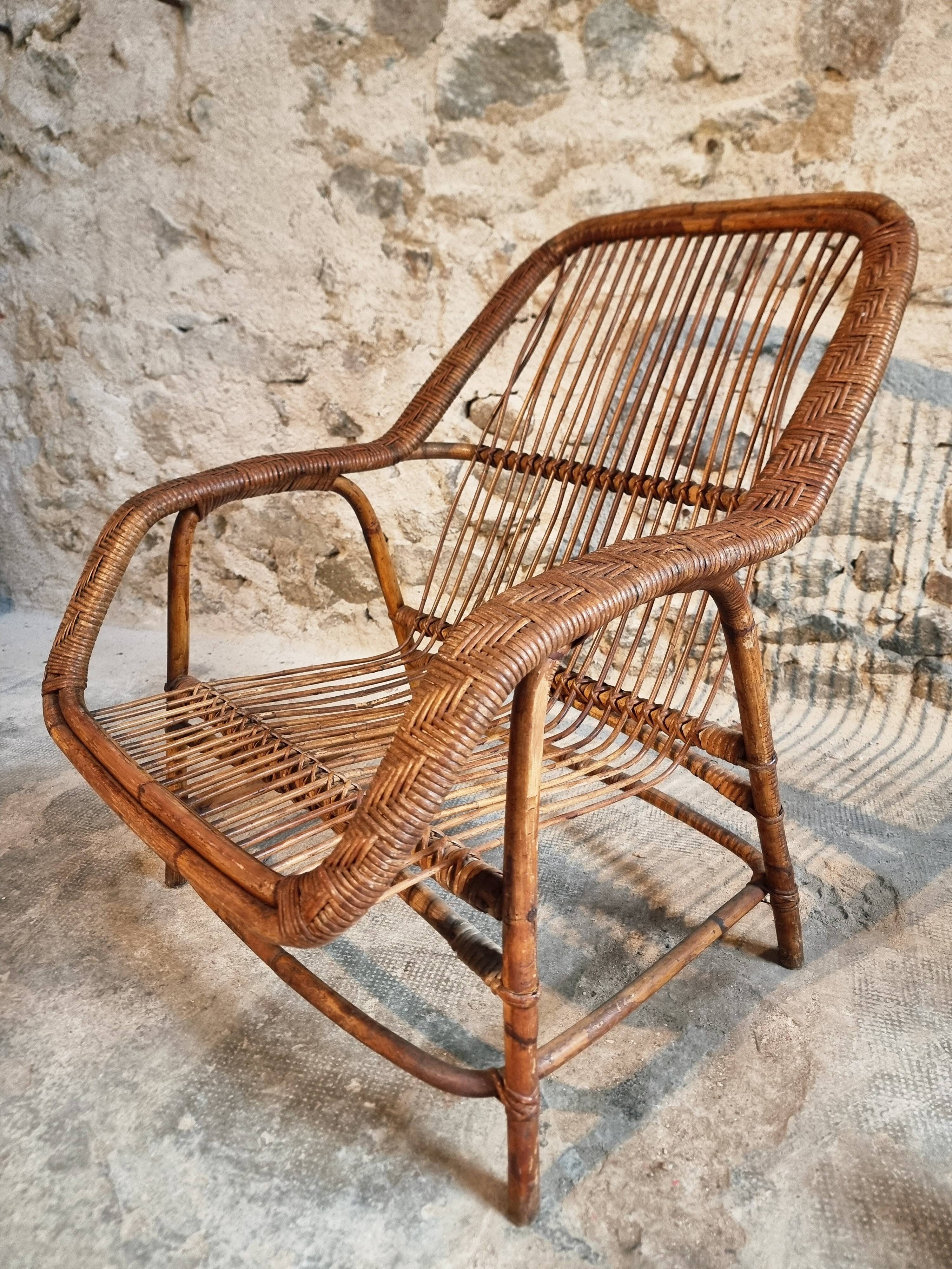 Vintage rattan lounge set, French wicker armchairs and round table, circa 1930–1950.