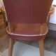 Skai chair binds wine and wooden footpieces and armrests