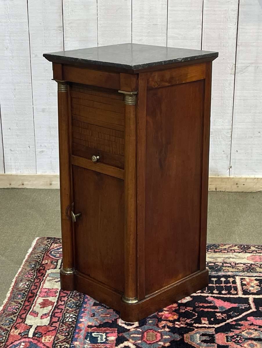 Empire bedside table from the 19th century in cherry wood and black marble.