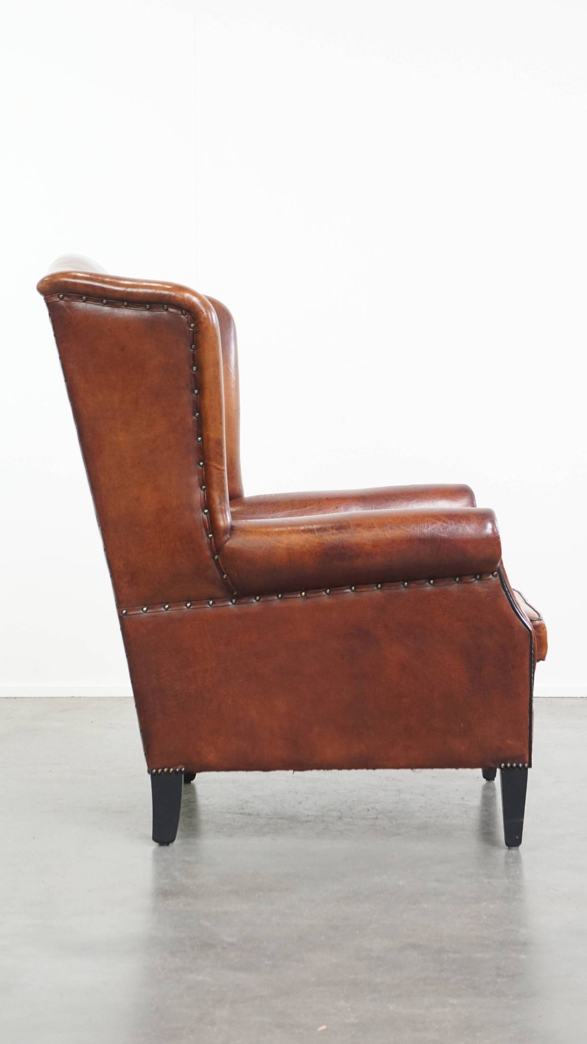 Sheepskin Wingback Chair with Warm Tones and Black Piping