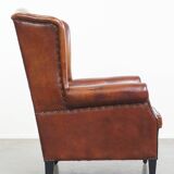 Sheepskin Wingback Chair with Warm Tones and Black Piping