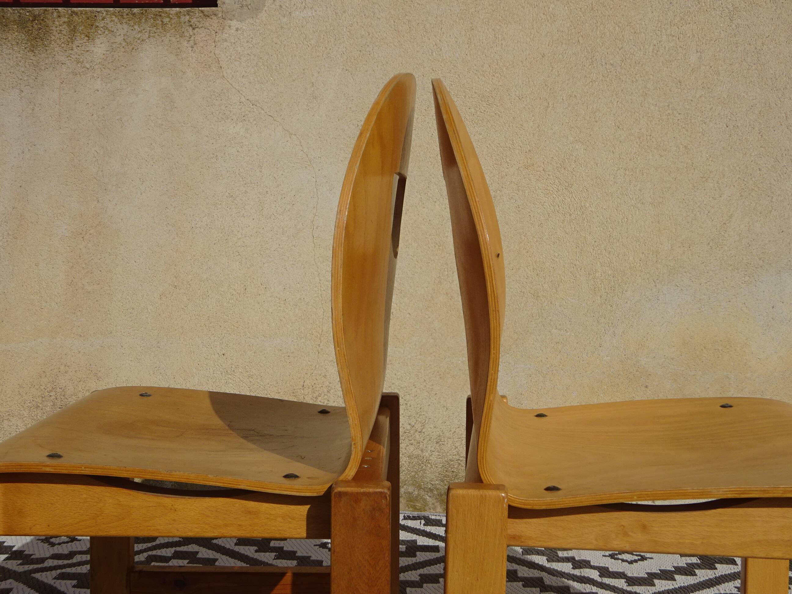 Pair of light wood chairs with post-formed seat and backrest.