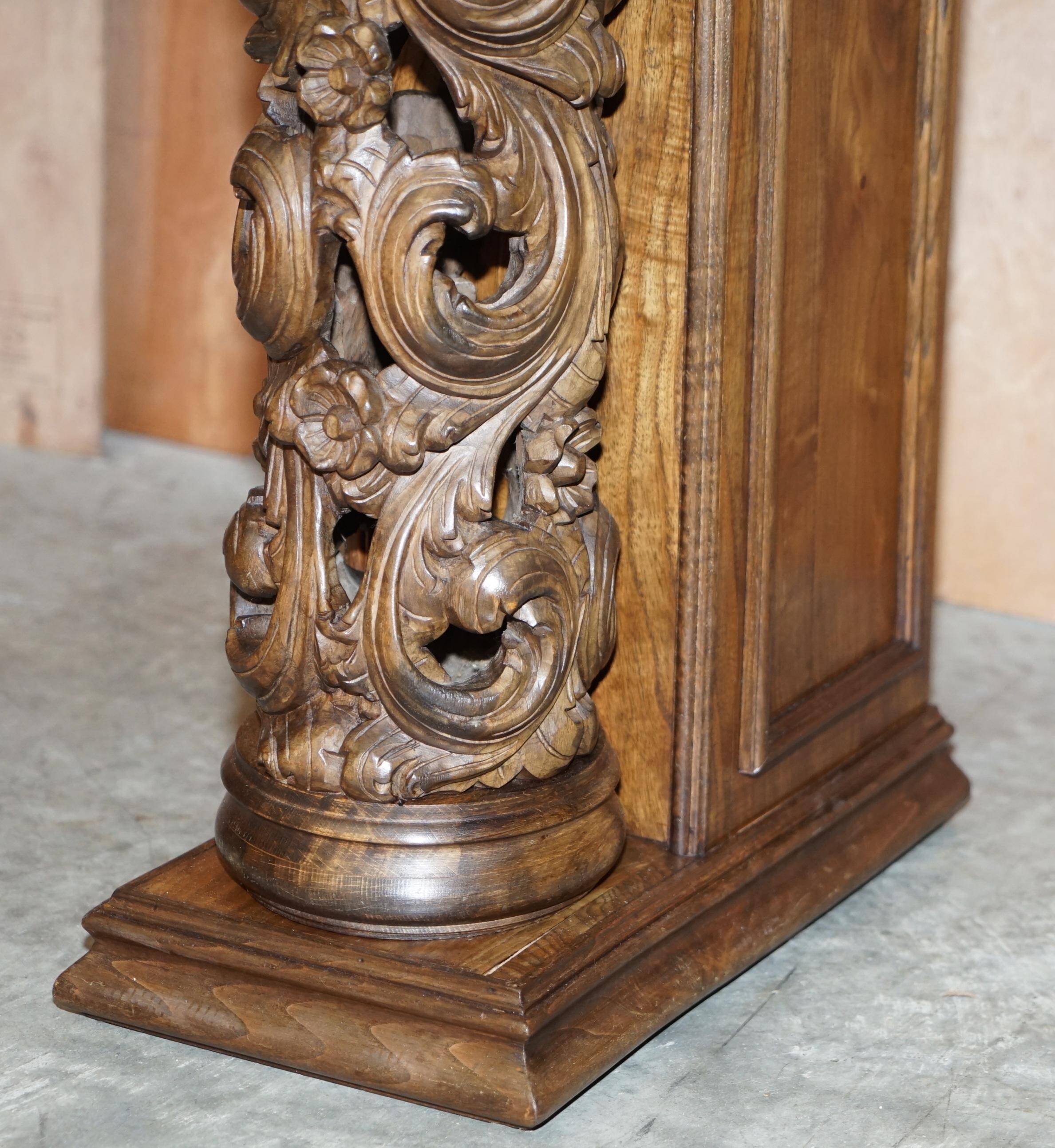 Antique fireplace from around 1880 in solid hand-carved elm with openwork columns.