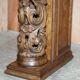 Antique fireplace from around 1880 in solid hand-carved elm with openwork columns.