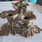 An antique pair of candlesticks with a floral design.