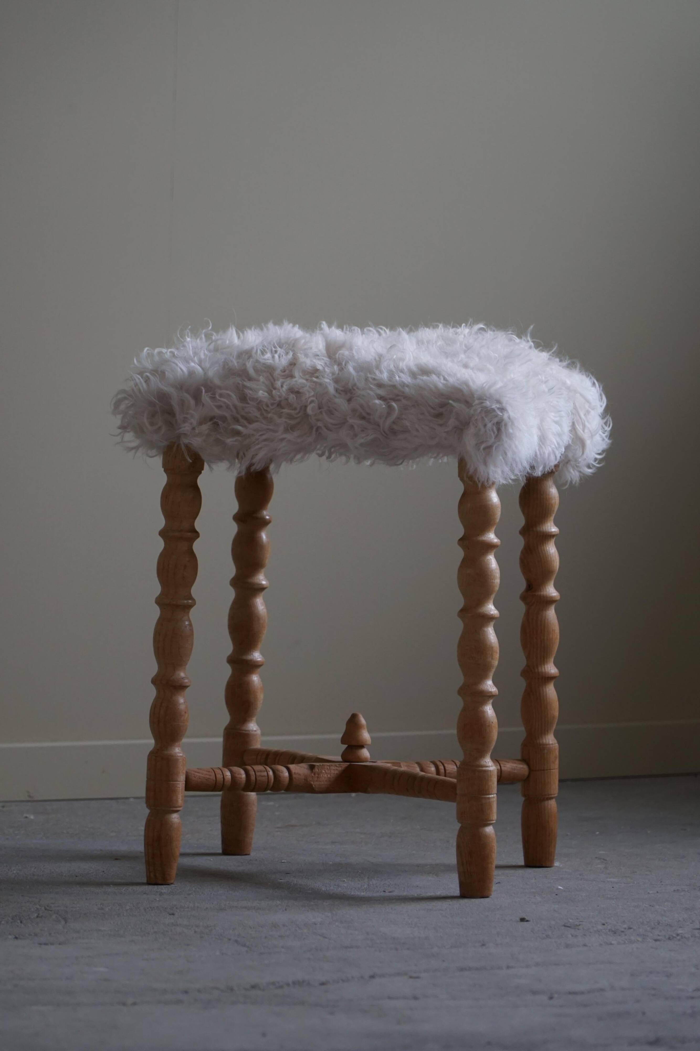High oak stool, reupholstered in lambswool, Danish cabinetmaker, 1950s.