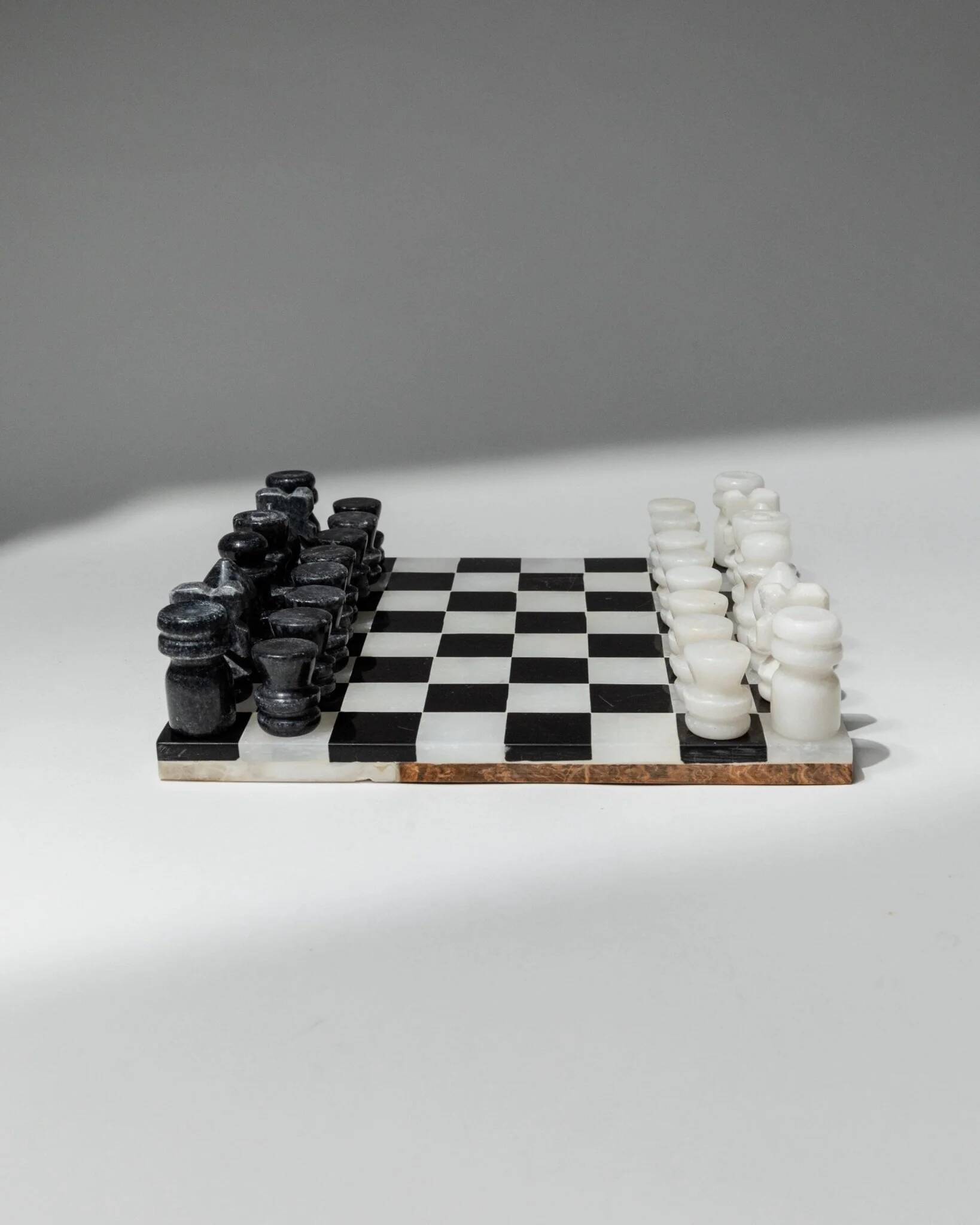 Vintage black-and-white marble chessboard with matching marble pieces, Italian 1960s design, sculptural centerpiece