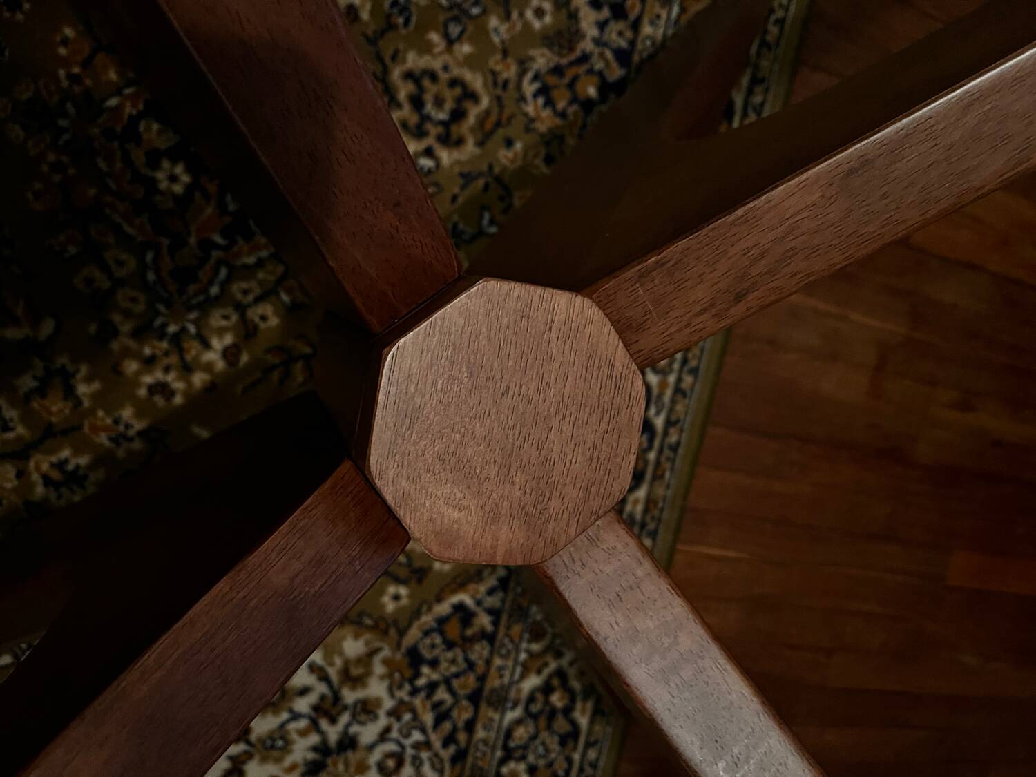 Round table made of solid wood with a walnut finish top.