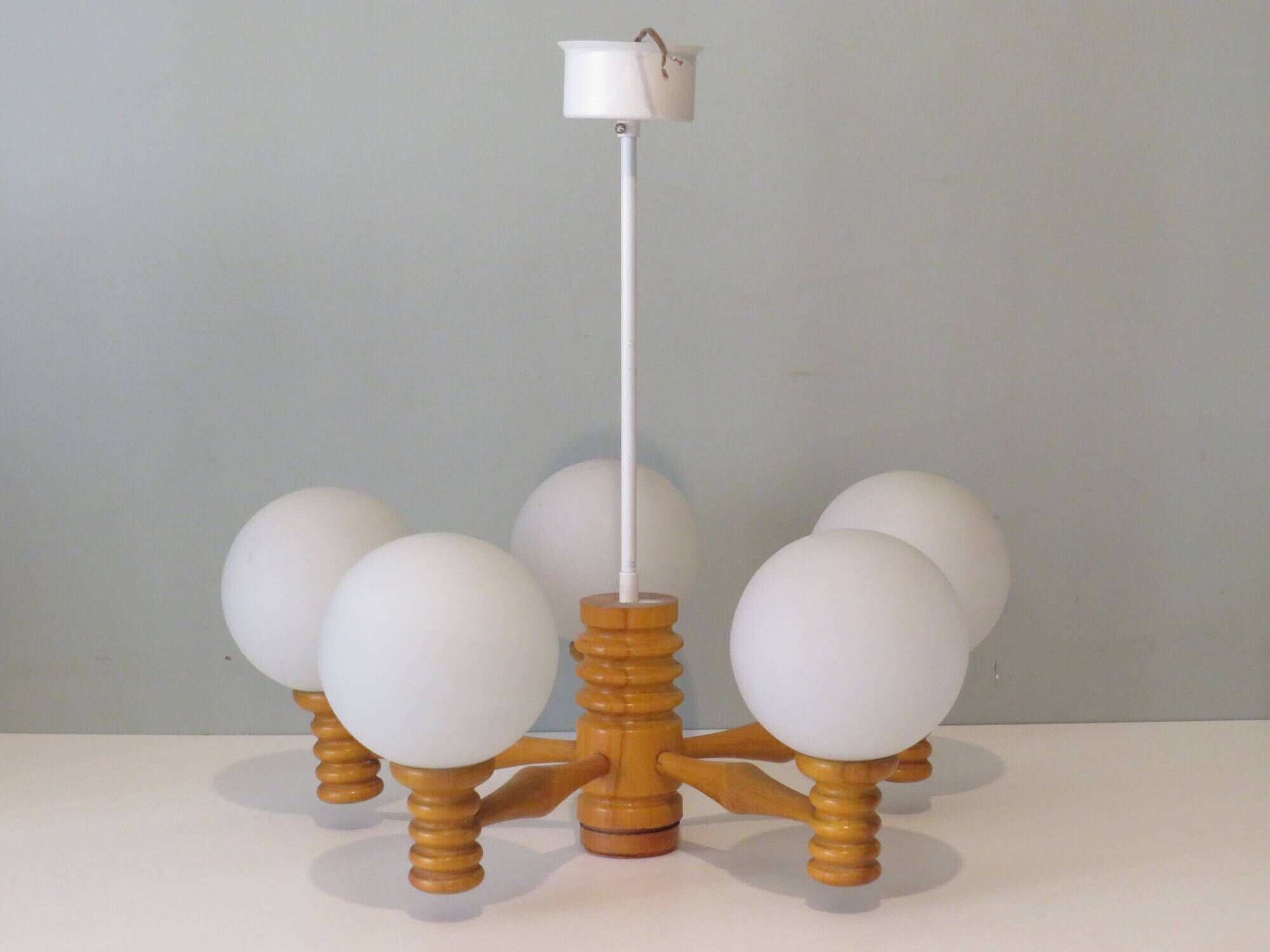 Space age chandelier in 5-arm wood with white frosted opaline glass spheres.
