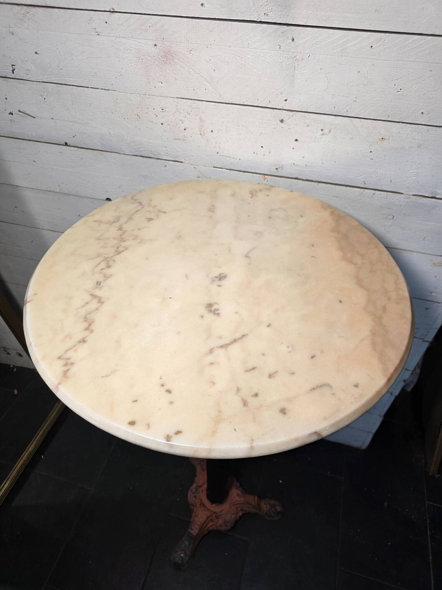 Bistro standing table with marble top and cast iron base.