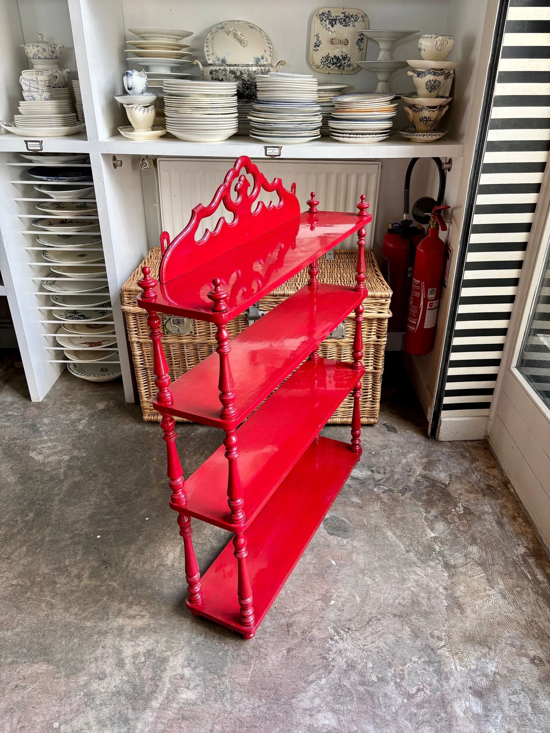 Wall shelf with 4 red lacquered wooden shelves.