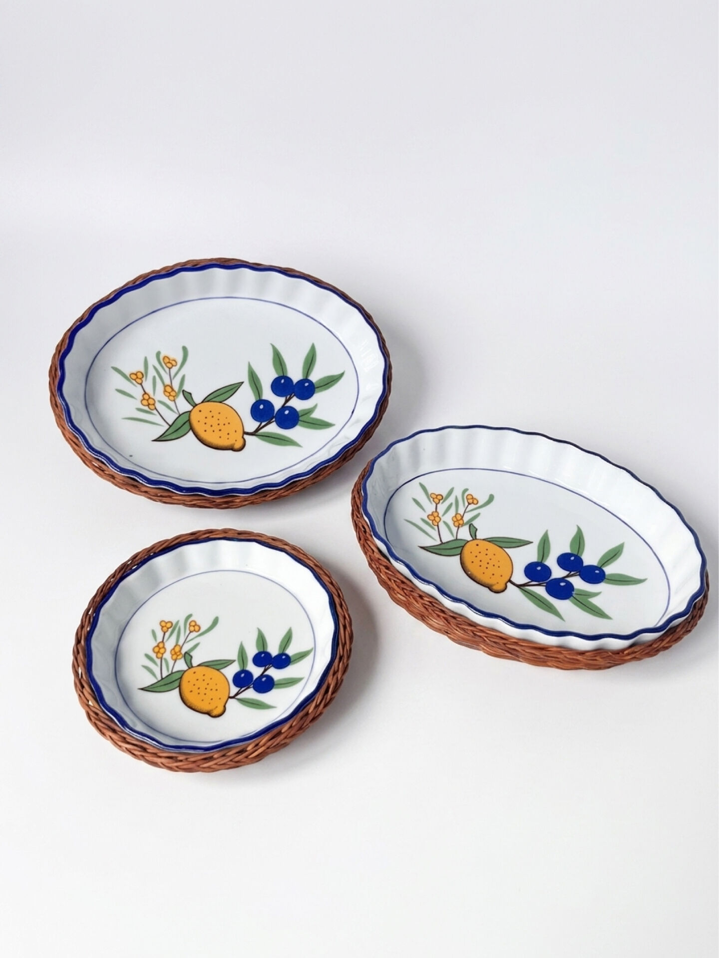 Set of 3 vintage ceramic dishes with wicker baskets.