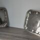 2 rectangular silver-plated metal dishes with an 80s pattern.