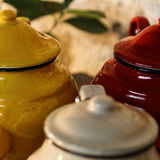 Trio of small enamelled teapots