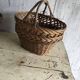 Set of 2 brown wicker baskets from the 1960s — decorative weaving and double handles.