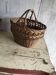 Set of 2 brown wicker baskets from the 1960s — decorative weaving and double handles.