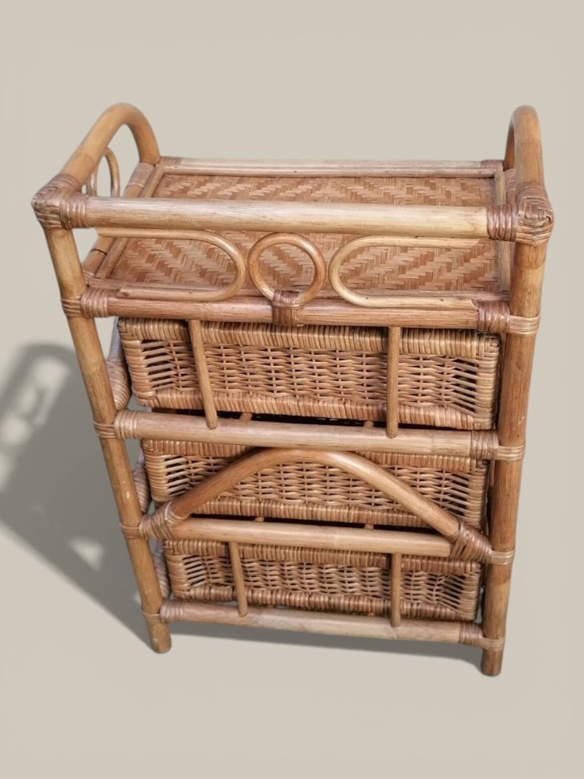 Small storage unit / freestanding shelf in light rattan.