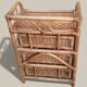 Small storage unit / freestanding shelf in light rattan.