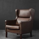 Brown leather wingback chair in mid-century modern Danish style, 1960s.