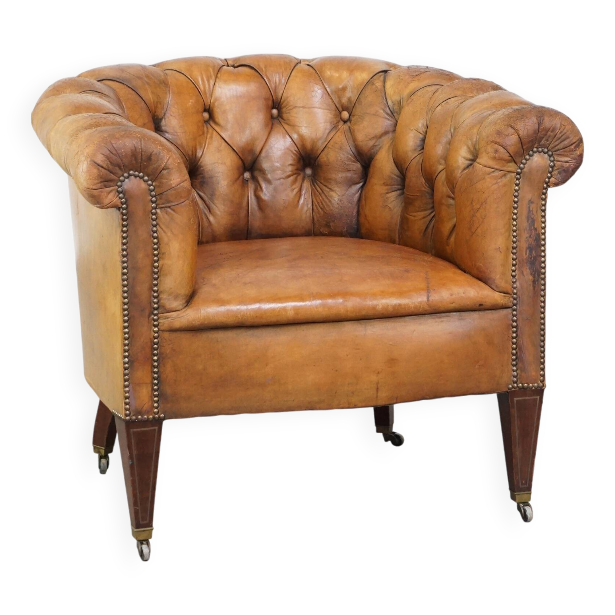 Antique, characteristic sheepskin chesterfield club chair on wheels