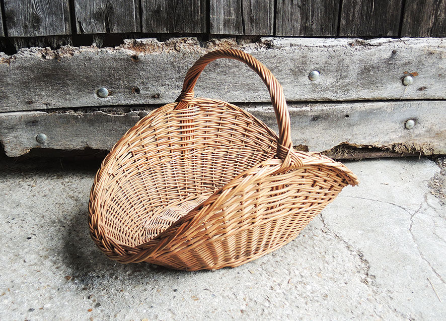 Old basket with logs in light wicker