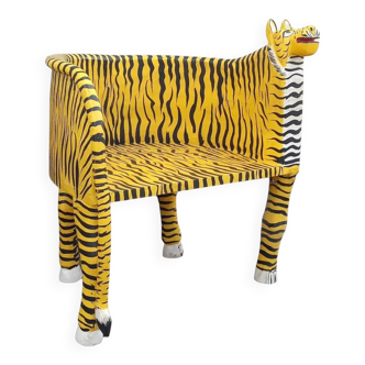 Wooden armchair with a "tiger" appearance.