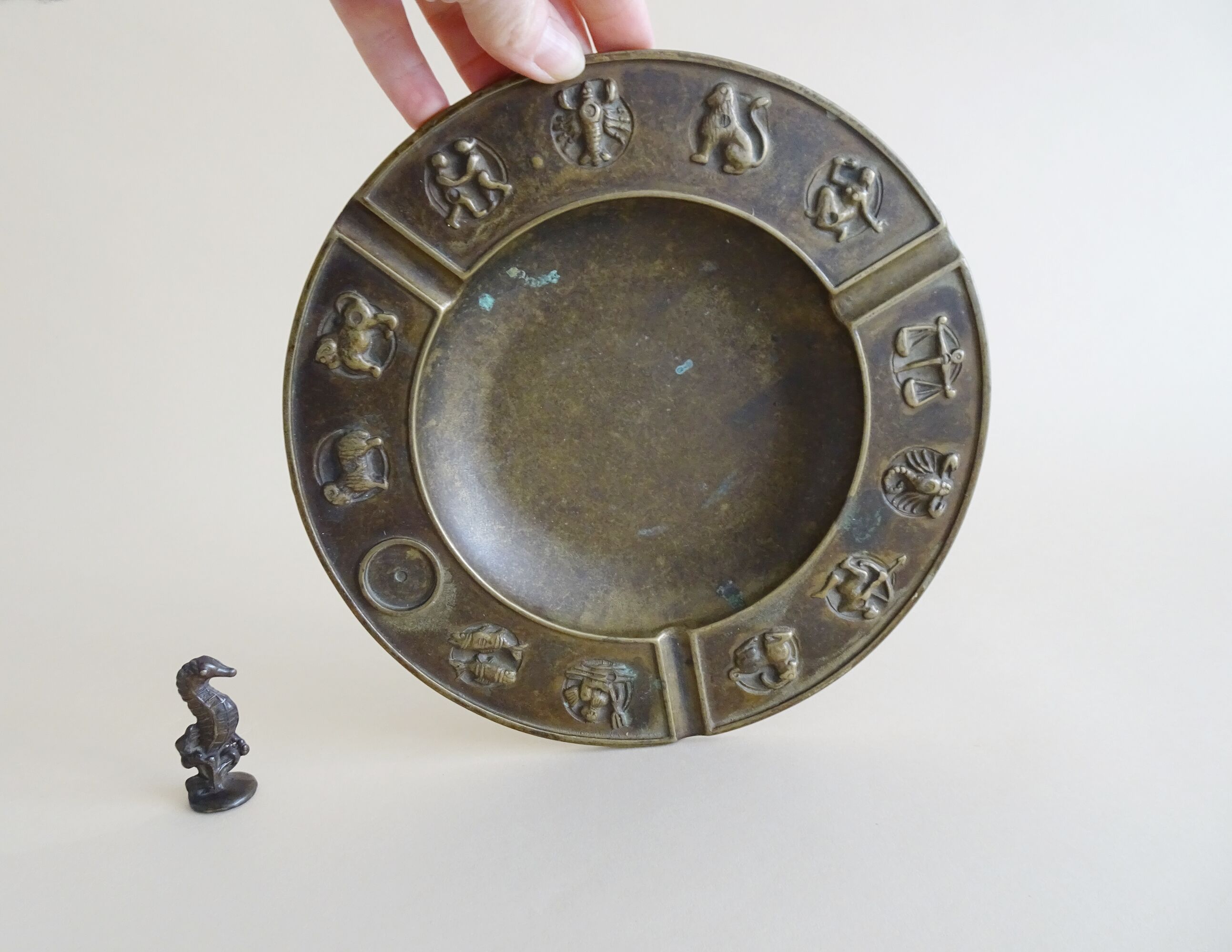 Luxa brass ashtray with zodiac relief and embers killer