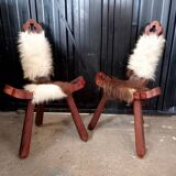 Pair of brutalist tripod chairs in wood and cowhide