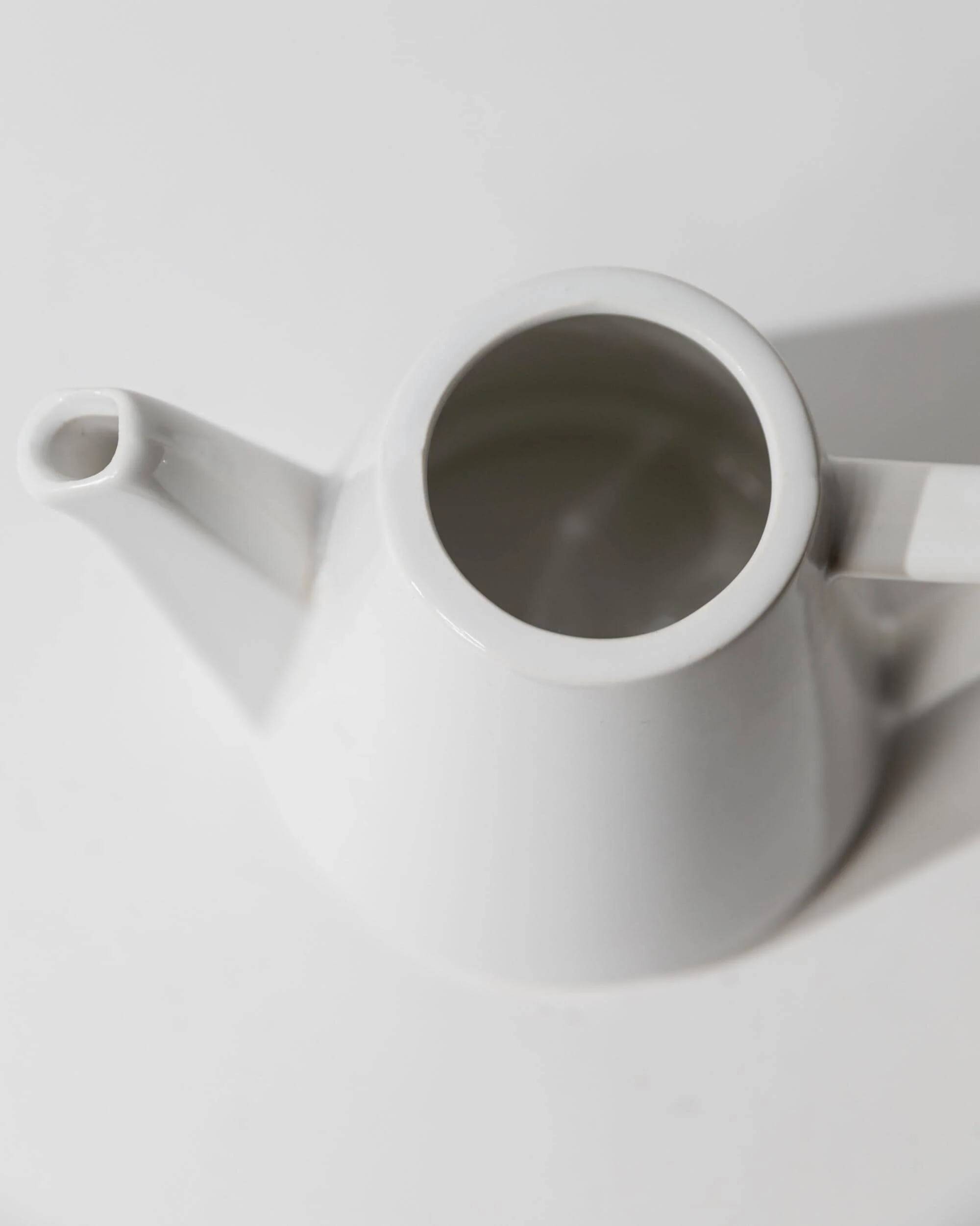 Vintage ceramic coffee pot or teapot from the 1980s, postmodern Memphis design, black and white triangles.