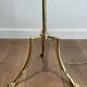 Brass floor lamp with a tripod base and claw feet from Maison Jansen.