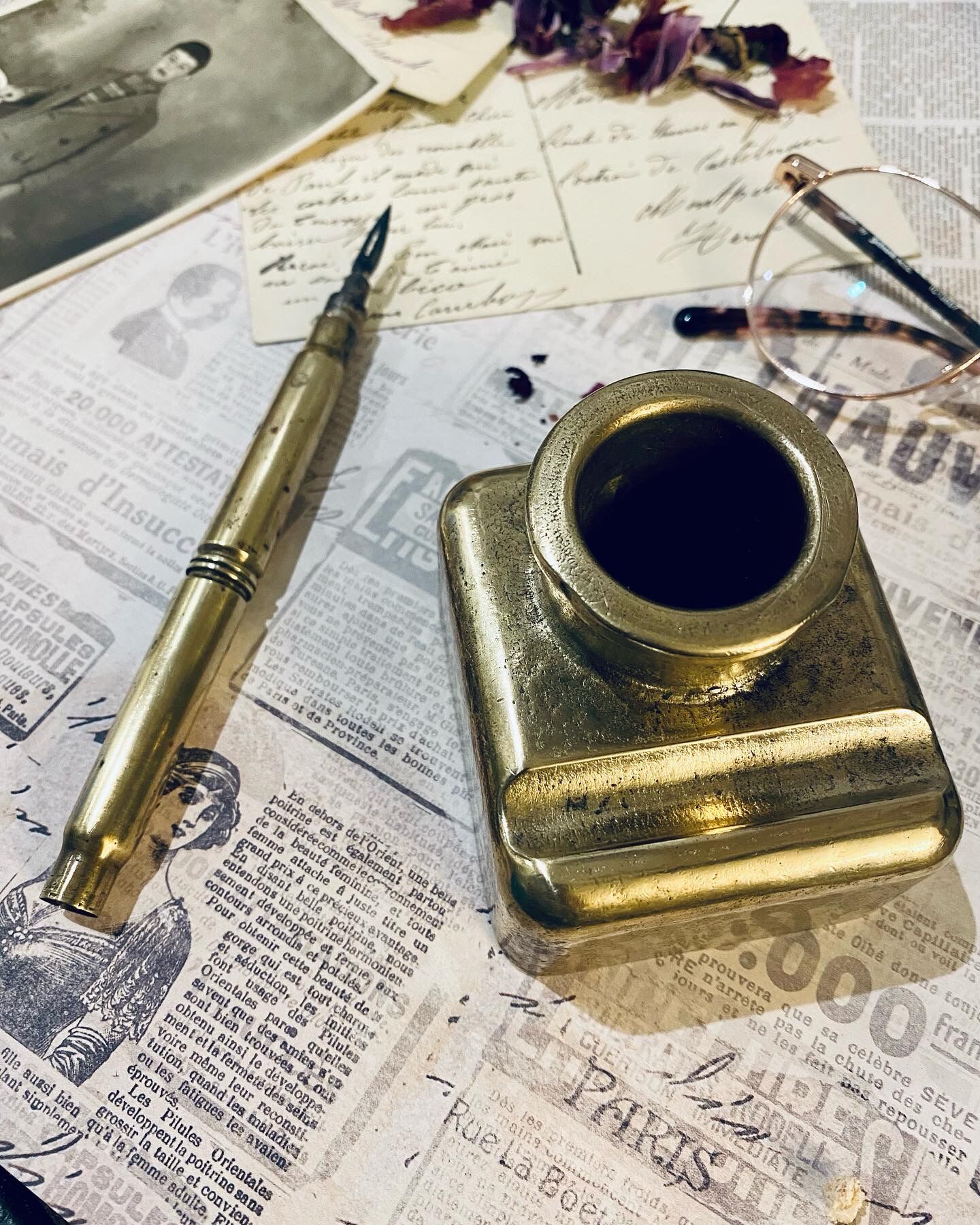 Brass inkwell and old feather holder