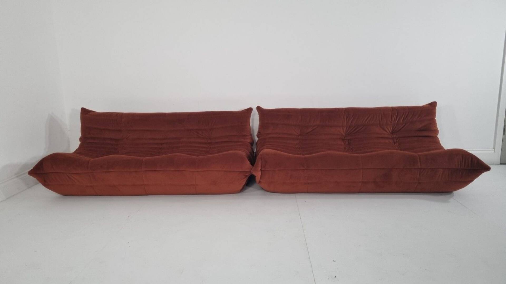 Ligne Roset Pair of 3-seater Togo sofas in rust velvet