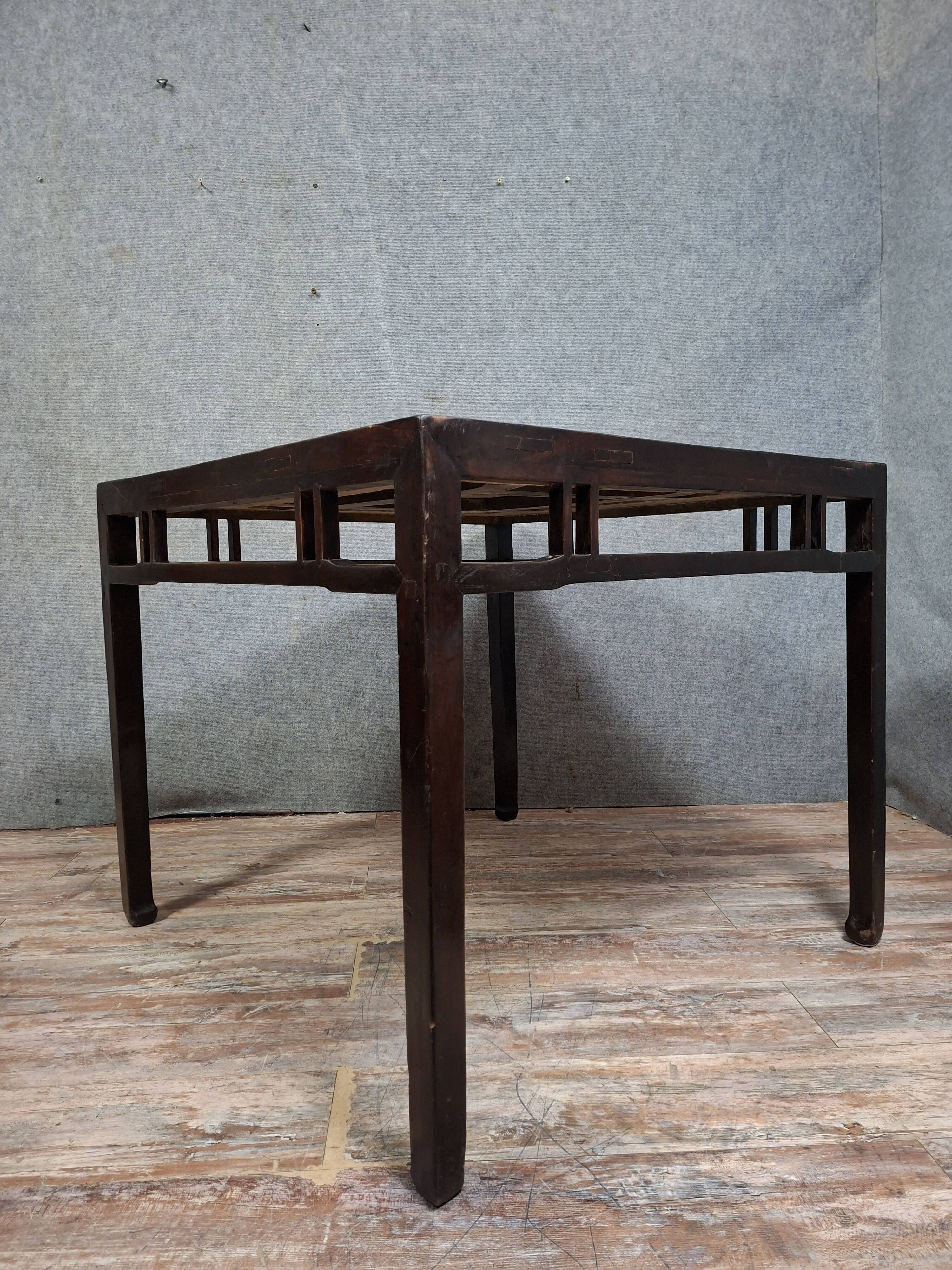 ancient Asian table, made of solid wood with a dark brown patina