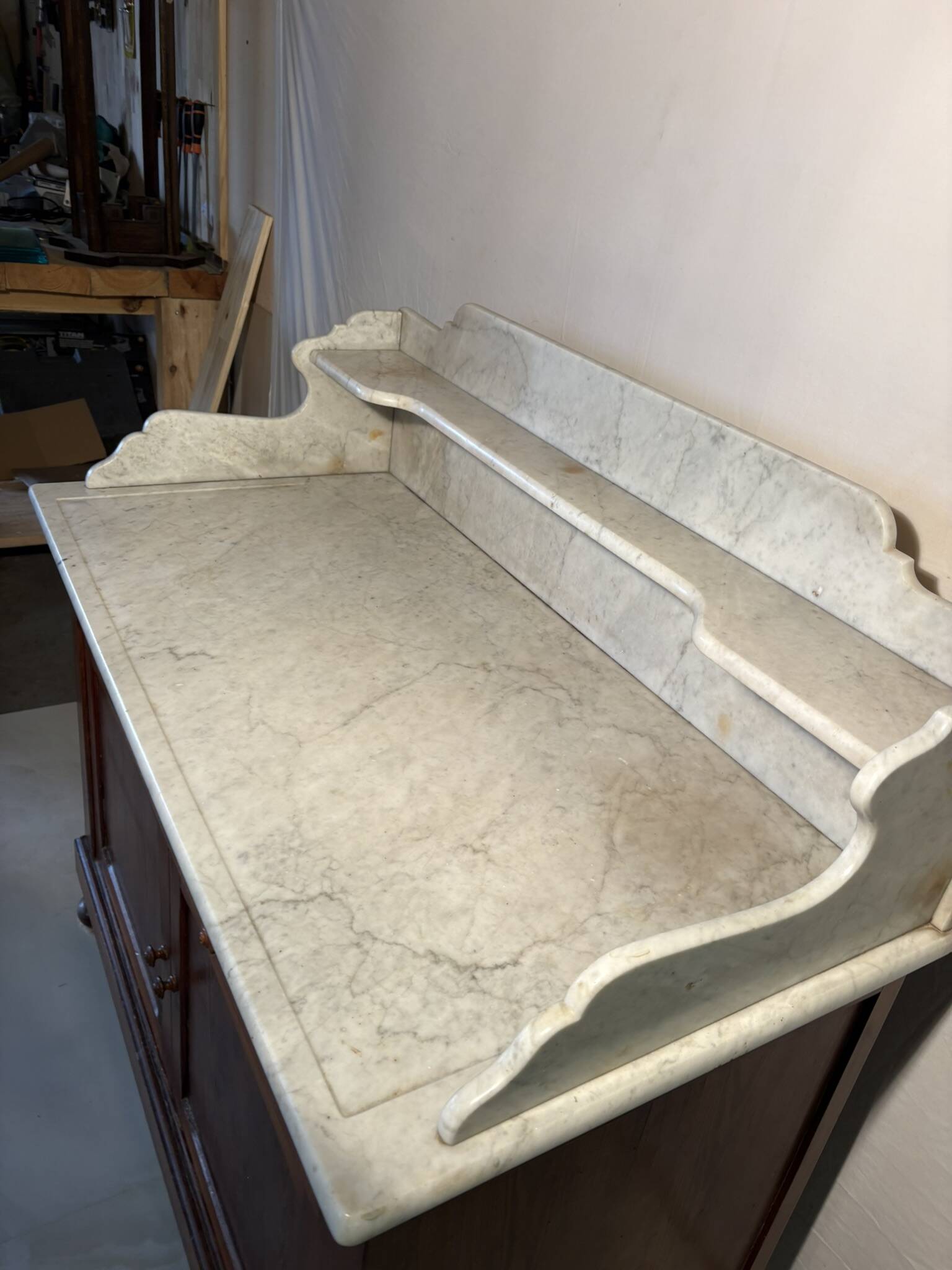Antique wood and marble kitchen sideboard with carved backsplash