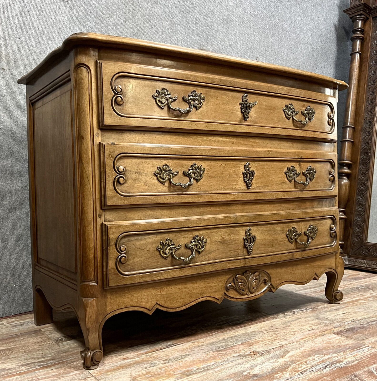 Curved Louis XV style chest of drawers in solid wood with a light patina