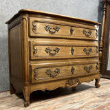 Curved Louis XV style chest of drawers in solid wood with light patina