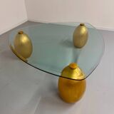 Vintage Italian design coffee table with a glass top and gold base, dating from the 1980s.