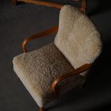 Pair of Mid Century Modern Swedish lounge chairs in birch and lamb's wool, 1960s.
