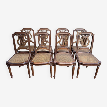 Suite de 8 chaises de style Louis XVI en cannage