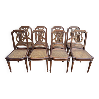 Suite de 8 chaises de style Louis XVI en cannage