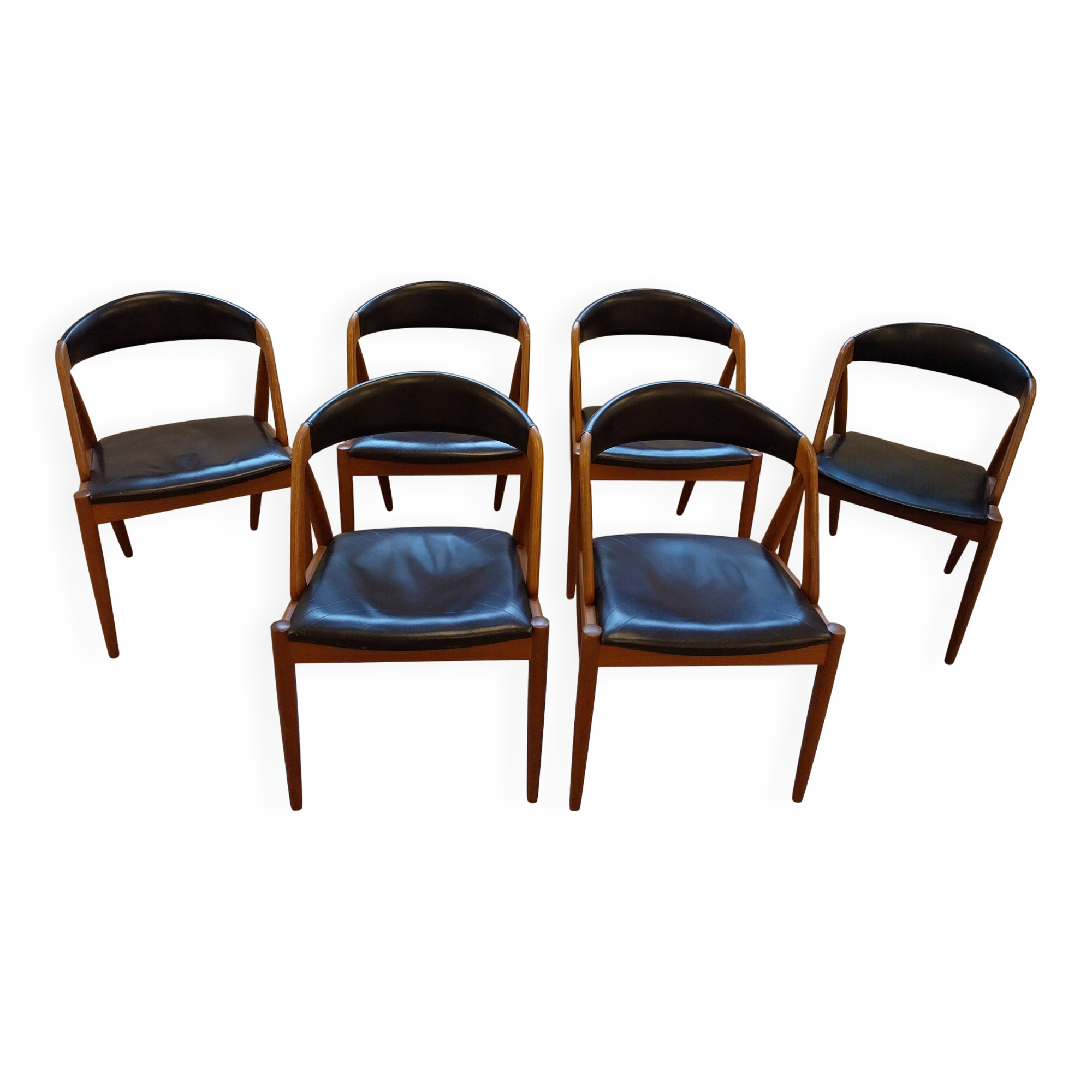 Set of 6 vintage Kai Kristiansen chairs in solid teak and black faux leather.