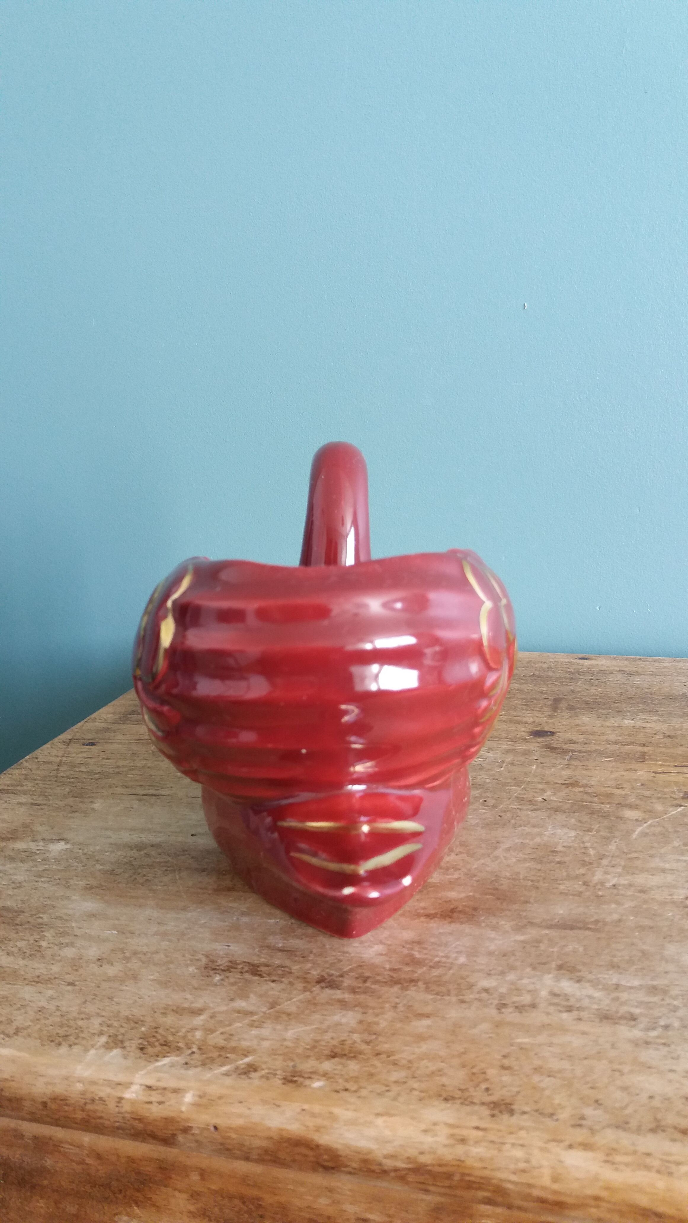 Poet Laval swan hides zoomorphic pot in burgundy ceramic.