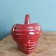 Poet Laval swan hides zoomorphic pot in burgundy ceramic.