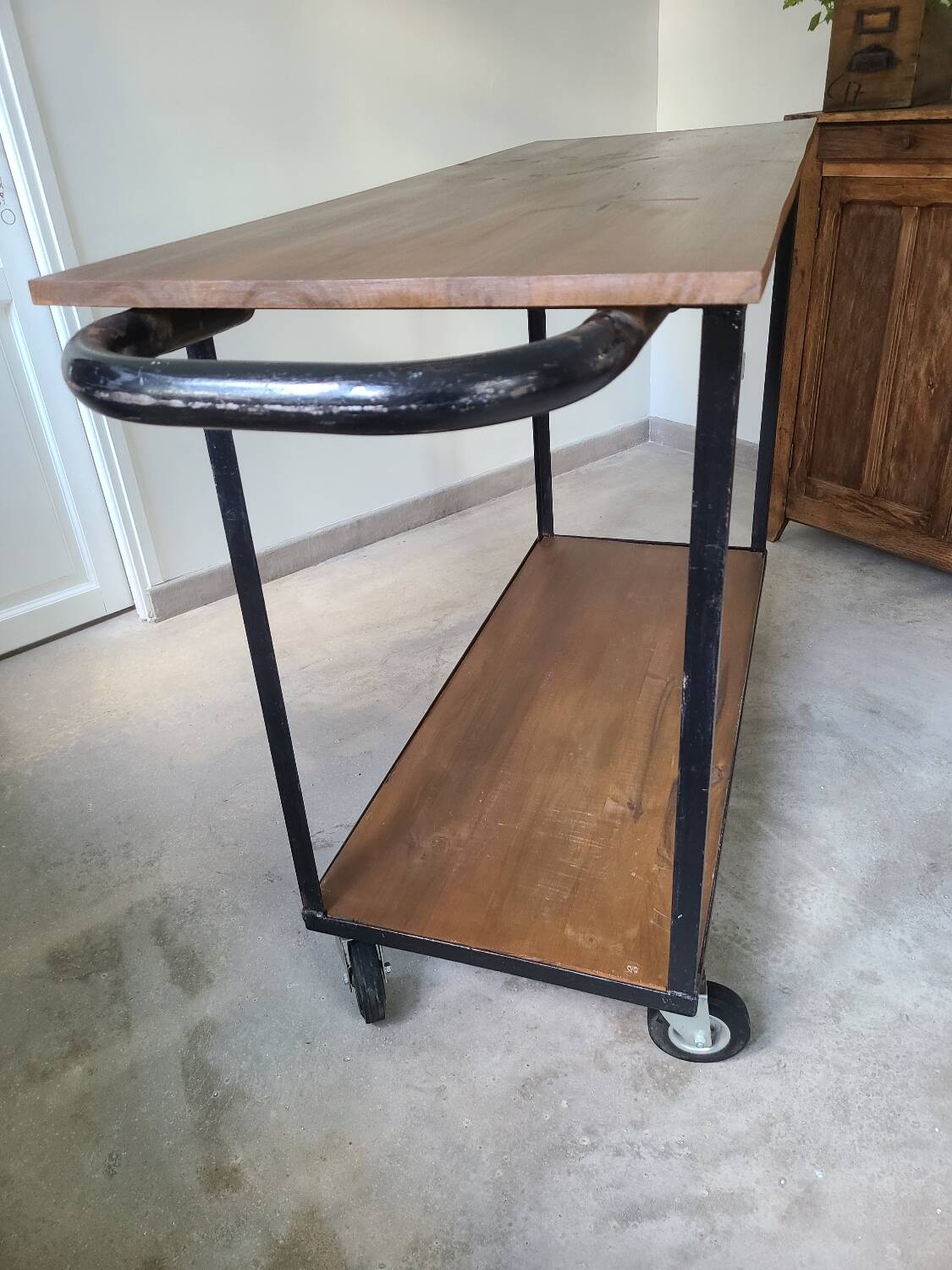 Large central kitchen island trolley on wheels serving industrial console