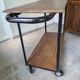 Large central kitchen island trolley on wheels serving industrial console