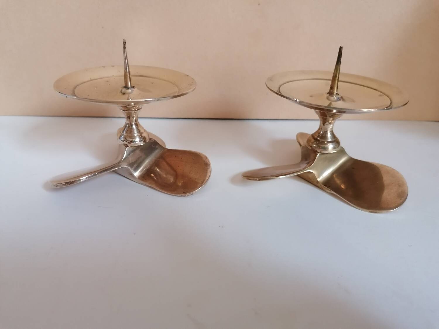 Two brass aviation propeller candle holders