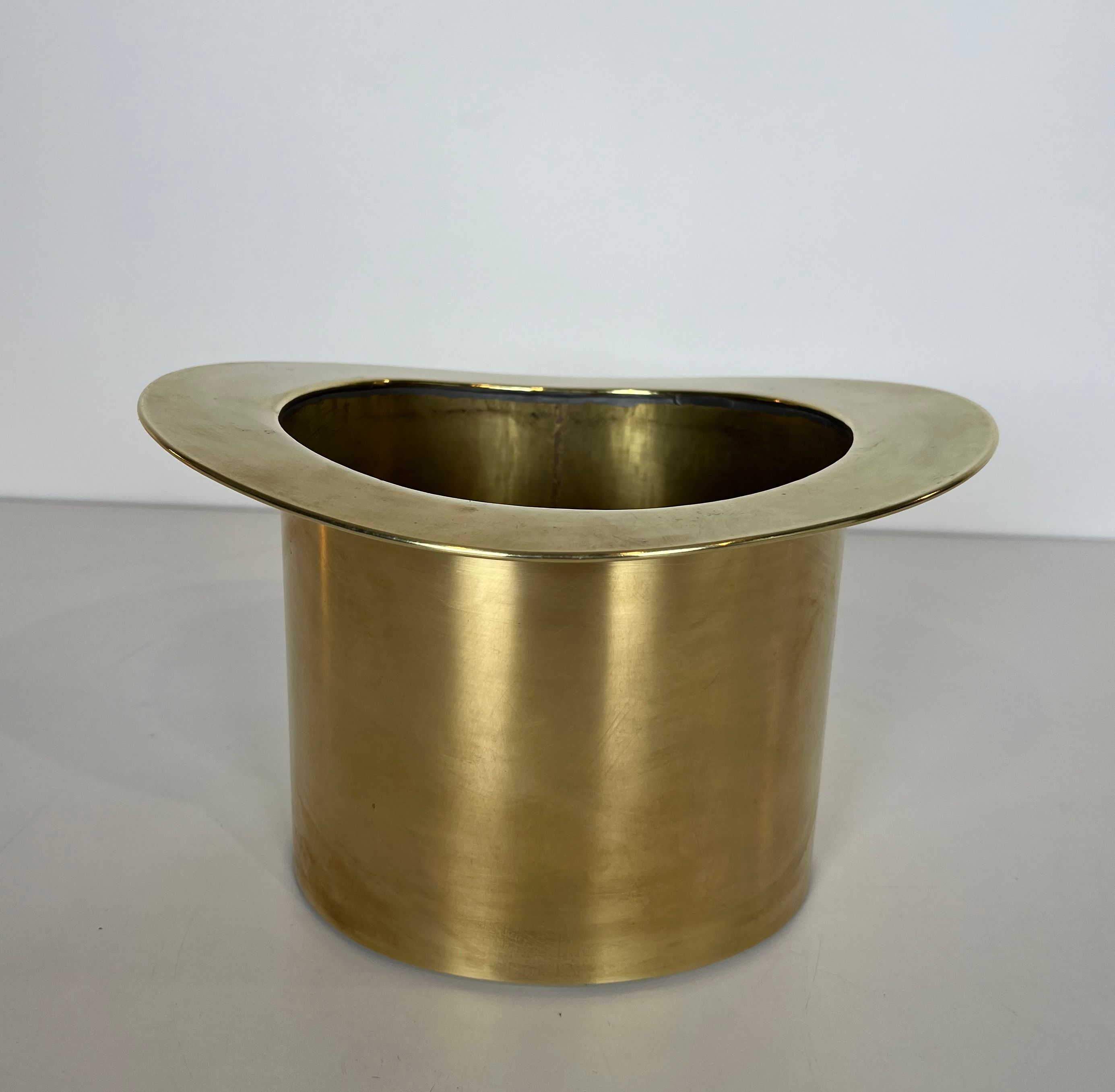 Champagne cooler shaped like a brass top hat.