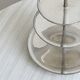 Vintage three-tiered serving stand in patinated silver metal.