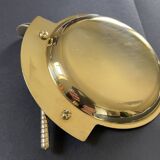 Round brass pocket tray with club and golf ball decoration.