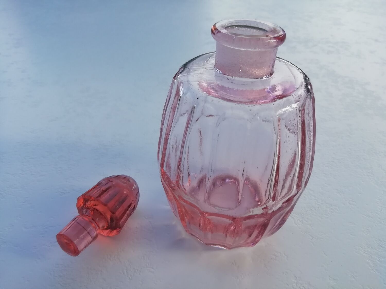 Pink molded glass bottle